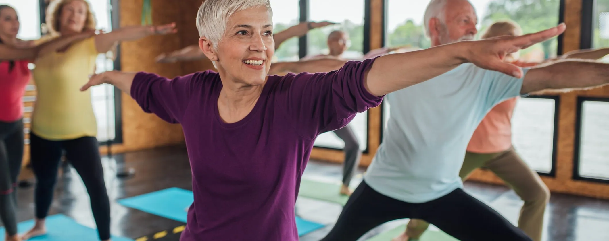 Group of seniors attending a yoga class.